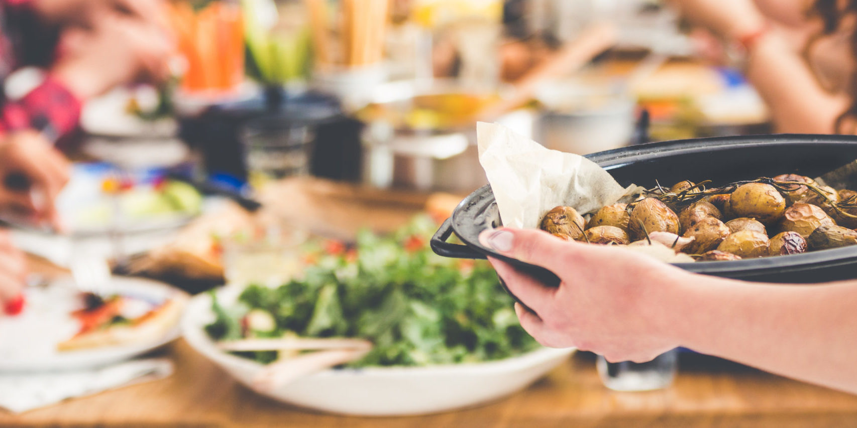 Serving roasted potatoes on tray