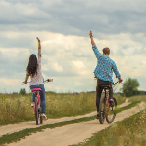 The man and woman riding a bike outdoor