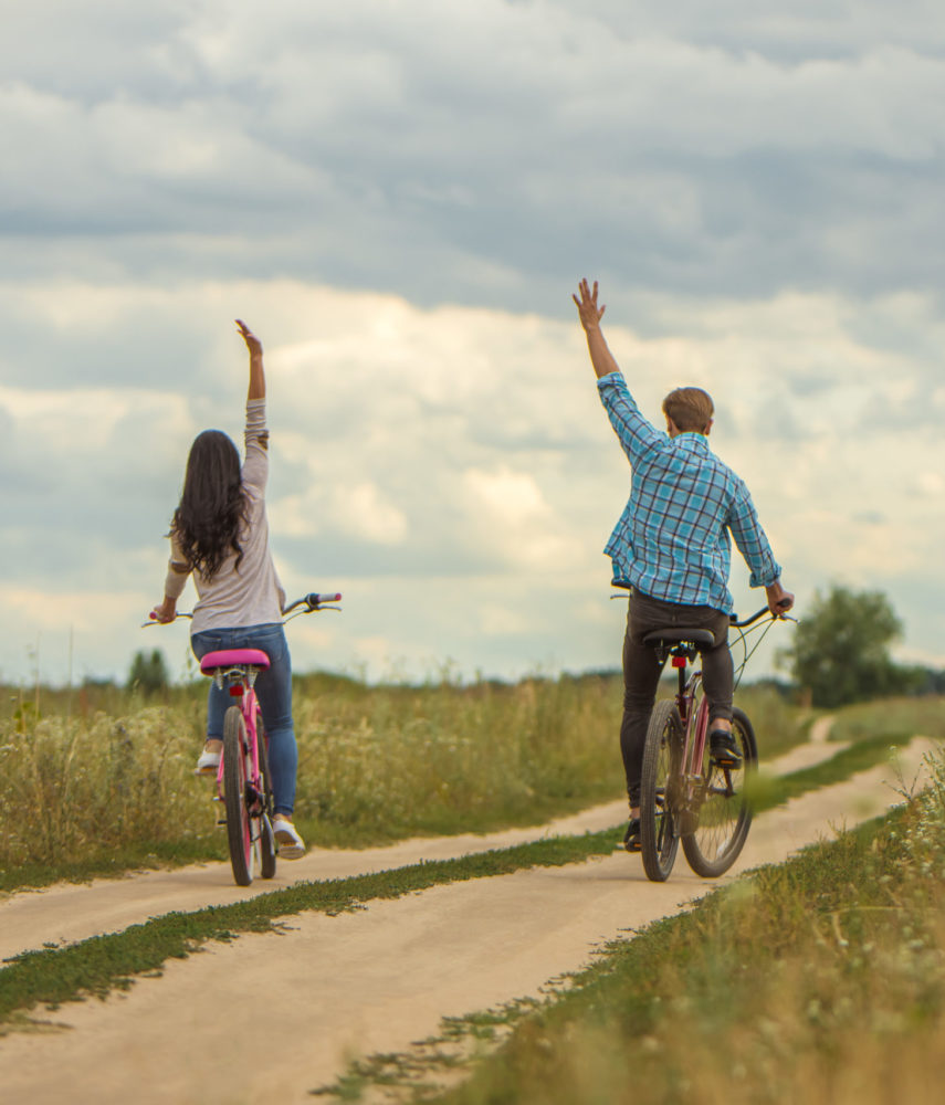 The man and woman riding a bike outdoor